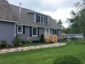 Beautiful updated stone pathway leading up to the door and out to the dock.