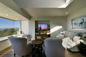 Living room features a flat screen TV, DVD player, and comfy seating for all