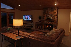 Enjoy a cozy wood fire or your favorite entertainment. 55" Smart TV with Roku