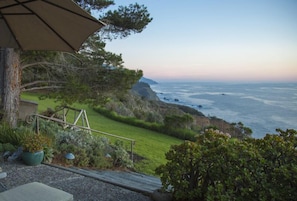 Patio steps to the lawn & cliff edge with South views of the coast