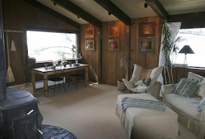 Living room & dining area with the fireplace and the cottage single sleeper sofa