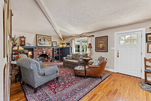 Comfortable living room with brick fireplace and artful touches