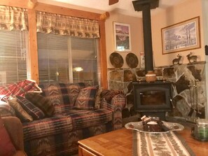 Cozy cabin living with wood burning fireplace 
