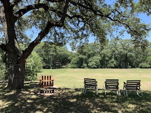 You won't believe you're in town! Deer and other wildlife graze in the meadow behind the cabin-and there are convenient chairs set up for wildlife watching.