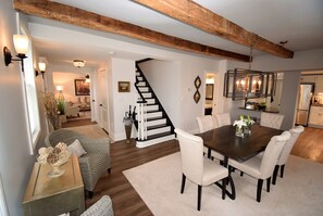 Elegant dining room features original beams