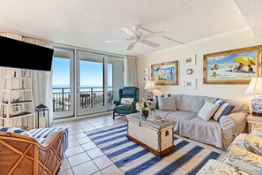 Living Area with Ample Seating, Large Flat Screen TV and Balcony Access