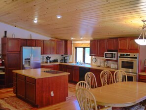 Kitchen is stocked with spices & paper products, 3 sets of dishes, pots 7 pans