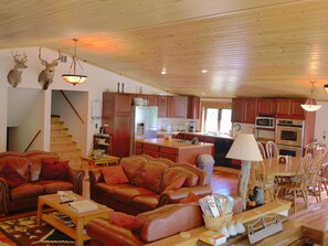 Gourmet Kitchen Has Flat Top Cooking Area in Island and Double Oven