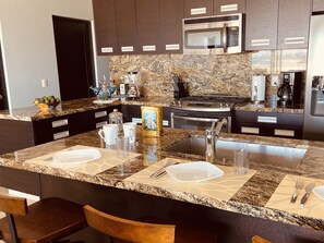 Fully equipped gourmet kitchen - stainless steel appliances, granite countertops