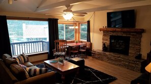 Living room, 60" Smart TV, Gas Log Fireplace, dining nook.