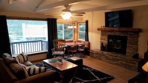 Living room, 60" Smart TV, Gas Log Fireplace, dining nook.