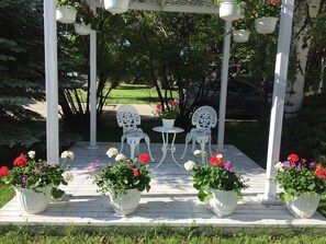 Front yard with large gazebo for guests with summer flowers!