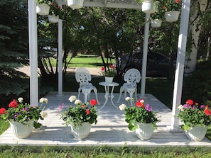 Front yard with large gazebo for guests with summer flowers!