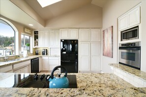 The kitchen has granite countertops and top-of-the-line appliances 
