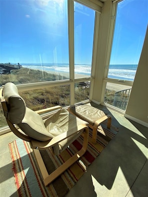 Reading nook in living room with panoramic views, nap-worthy chair