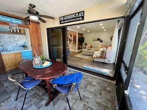 Patio wet bar, with sink and fridge facing the pool