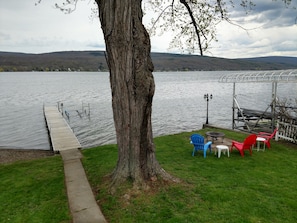 lake level yard with Beach access, fire pit, lawn chairs &  propane grill