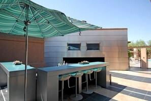 Outdoor TVs and sitting area at main pool off of Great room club house