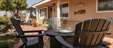 Enjoy the patio area with comfortable seating and a fire pit