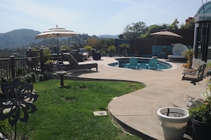 More recent picture with dinning table and umbrella. Daybed next to Hot tub!