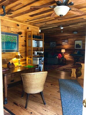 Upon entering, there is a writing table/office space with plenty of light.