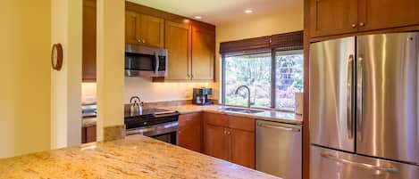 Updated & expanded kitchen with granite  counter tops & stainless steel applianc