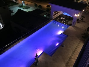 view of pool from balcony at night
