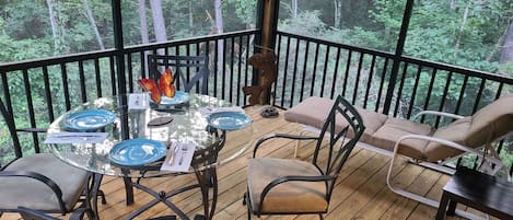 Screened porch next to kitchen overlooking woods listening to babbling stream