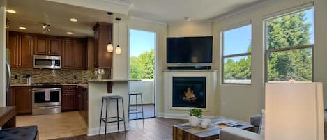 View of living room, kitchen, and 2nd floor balcony