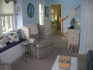 front foyer with view of front bedroom and living room window seats and stairs