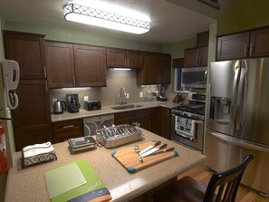 Kitchen is fully equipped with appliances, dinnerware and accessories