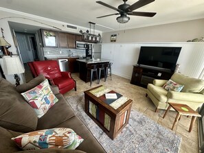 Open living space to enjoy 55” TV, fireplace and ocean front view