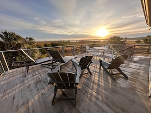 Six lounge chairs and a picnic table with umbrella for hanging out.