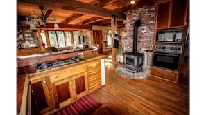view from well equipped kitchen towards living room, permits easy conversation