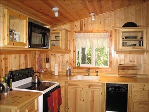 Kitchen with example of custom wood cabinetry that is found throughout the cabin