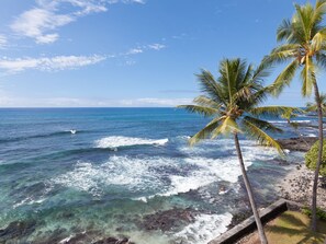 Looking down from lanai. Small white sandy beach next door (Banyan Surf).