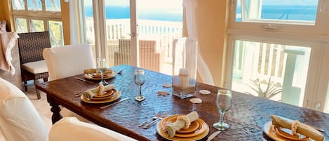 Dining room area, surrounded by seaviews, seats 4-6 around antique hammered teak