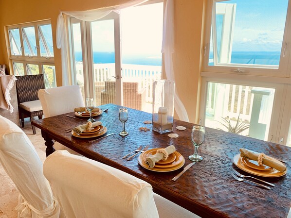 Dining room area, surrounded by seaviews, seats 4-6 around antique hammered teak