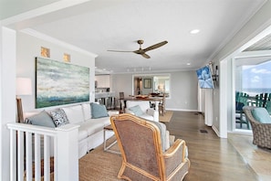 Open living room with views of the ocean throughout