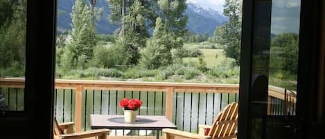 inviting view from inside of the deck, pond and Tetons.