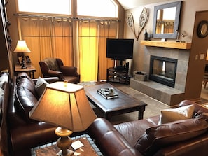 Great room, leather furniture, vaulted ceiling, gas fireplace & patio deck doors