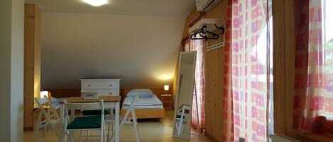 room with 4 single beds and air condition