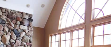 Living Room with cathedral ceiling, stone fireplace and flat screen tv