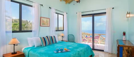 The master bedroom has its own balcony and enjoys amazing ocean views.