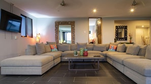 The living room is very large and contains this U-shaped sectional. 