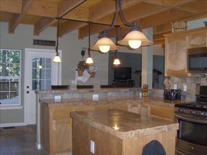 View of kitchen from the corner sink looking towards front door and great room