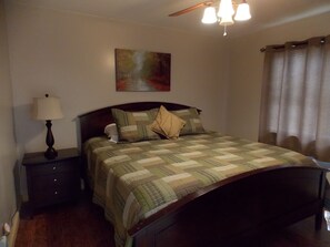 Main floor bedroom with king size bed.  32 inch TV, DVD player, and cable.
