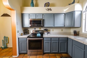 Refinished cabinets and fully stocked kitchen.