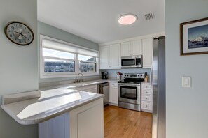 Updated and Fully Equipped Kitchen with Granite Countertops and Stainless Steel Appliances