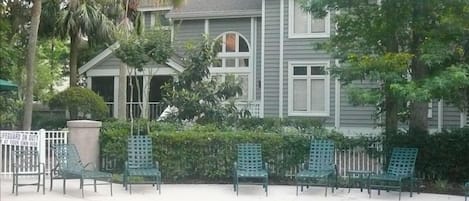 Back of our Villa showing screened porch, 2 story living room window and pool.